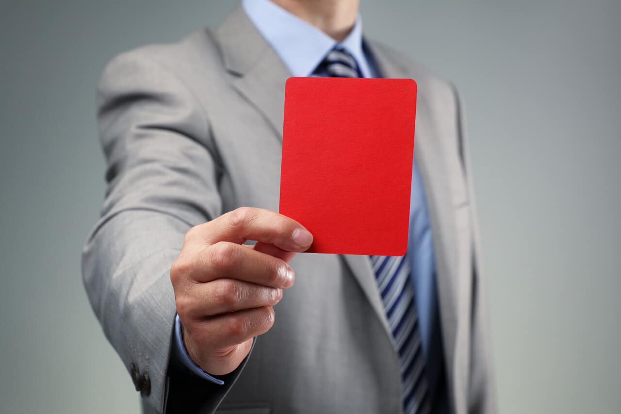 Businessman showing the red card penalty