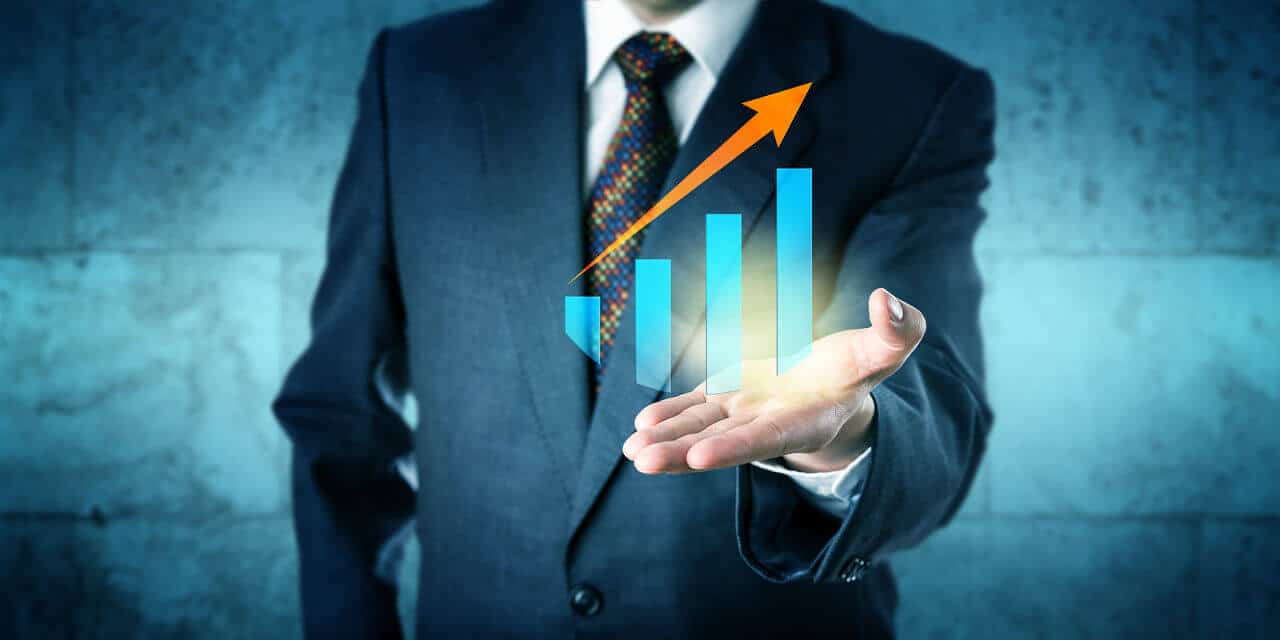 Save Download Preview Manager in blue business suit is offering a virtual growth chart with upward soaring trend arrow in the upward facing open palm of his left hand.