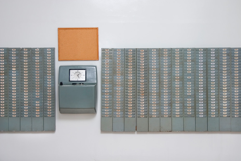 old fashioned punch card employee time clock